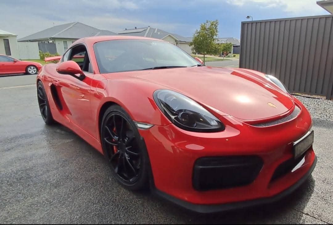 Red Porsche Cayman inspection